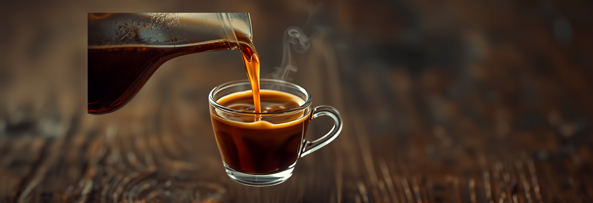 Thick, rich coffee pouring from a cafetiere into a small glass cup with visible syrupy texture and steam, showing a full-bodied cup.